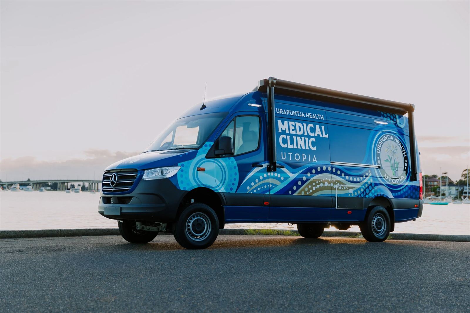 The Urapuntja Health mobile medical clinic, a four-wheel-drive Mercedes-Benz Sprinter carrying community-informed artwork.